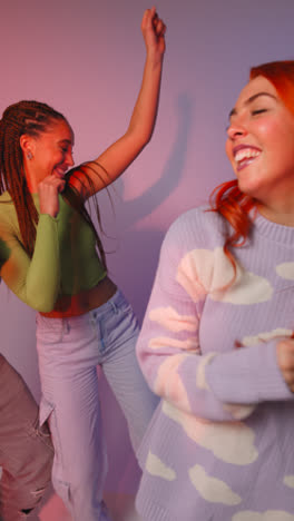 Vertical-Video-Studio-Shot-Of-Vertical-Video-Of-Group-Of-Gen-Z-Friends-Dancing-And-Having-Fun-Against-Pink-Background-2